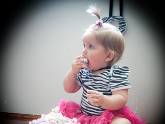 Little girl eating her butterfly cake