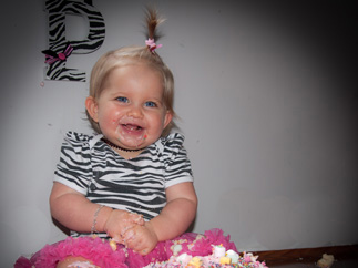 Baby and her birthday butterfly cake